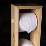 A toilet paper tower made out of scrap pine wood.