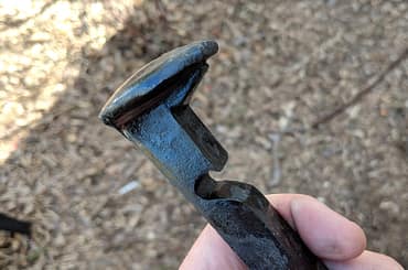Bottle opener made from a railroad nail or spike.